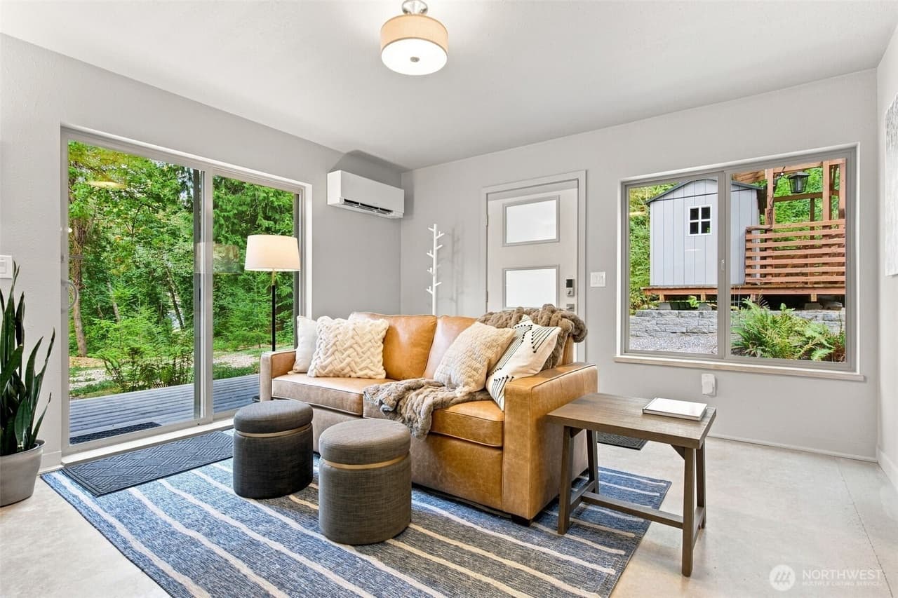 Lower-level living room with a sliding glass door and a separate exterior door to the outside.